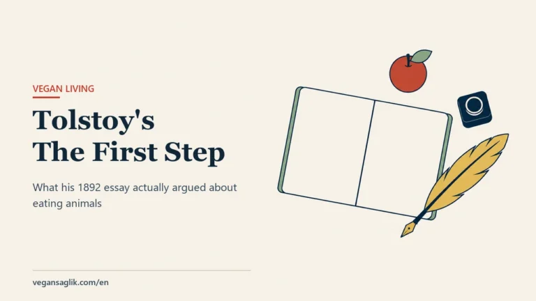 Editorial cover for an article on Tolstoy's 1892 essay The First Step. On the right, an open notebook is seen from directly above; both facing pages are completely blank, with a sage green cover band showing along the outer edge. A small red apple with a green leaf sits at the upper right, a dark navy ink bottle below it, and a soft gold feather quill lies diagonally beneath them with its tip pointing toward the corner of the notebook. No writing or lettering appears on any surface. On the left, the title Tolstoy's The First Step and the line about what his 1892 essay actually argued about eating animals.
